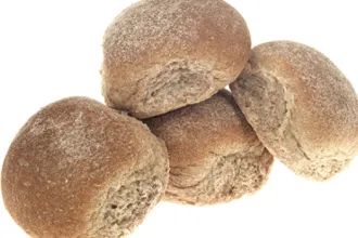 Stack of four whole wheat rolls.