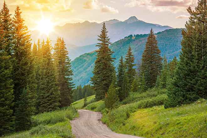 PROMO Outdoors - Mountains Trees Road Landscape Sun - iStock - welcomia