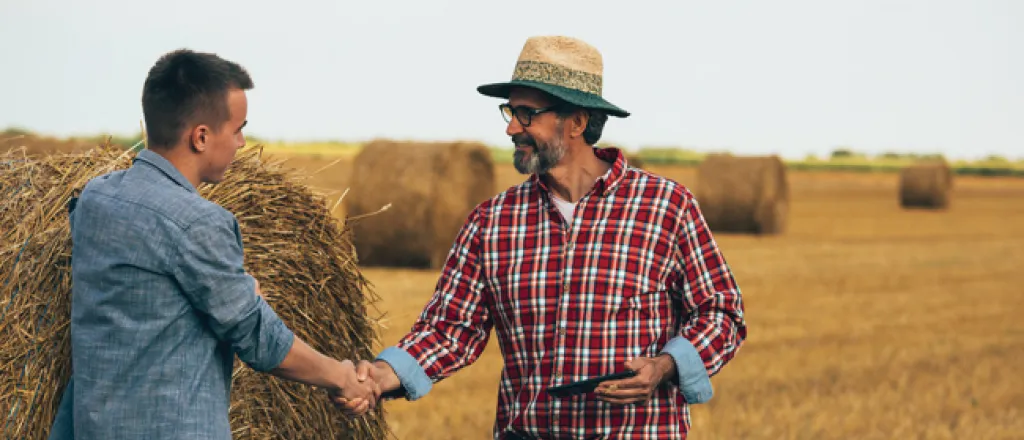 PICT Two people standing near a large hay bale - FamilyFeatures PICT Two people standing near a large hay bale - FamilyFeatures