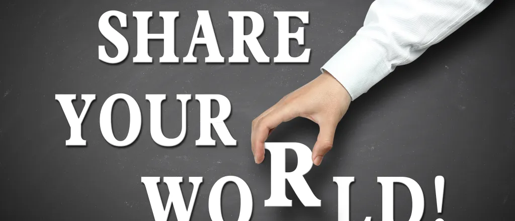 PROMO HIRES Community - Words Letters Share Your World Story - ChristianChan - iStock-476118892 Words "share your world!" on a grey background with a hand picking up the letter 'r' in world