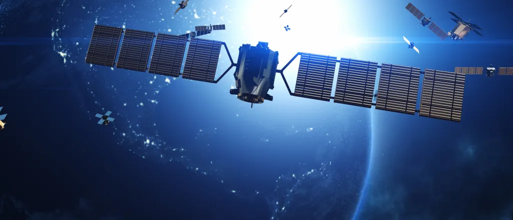 PROMO HIRES CROPPED Communication - Satellite Earth Space Globe - yucelyilmaz - iStock-2101393672 Concept image of satellites in orbit around a planet. A large satellite is in the foreground.