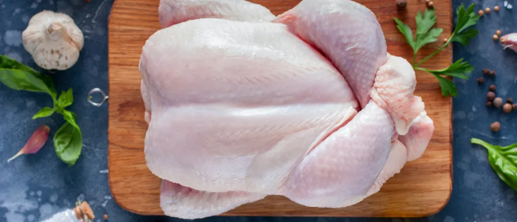 PROMO HIRES Food - Raw Turkey Cooking - Ann_Zhuravleva - iStock-1042438108 Overhead view of a raw turkey on a food preparation board surround by herbs and spices