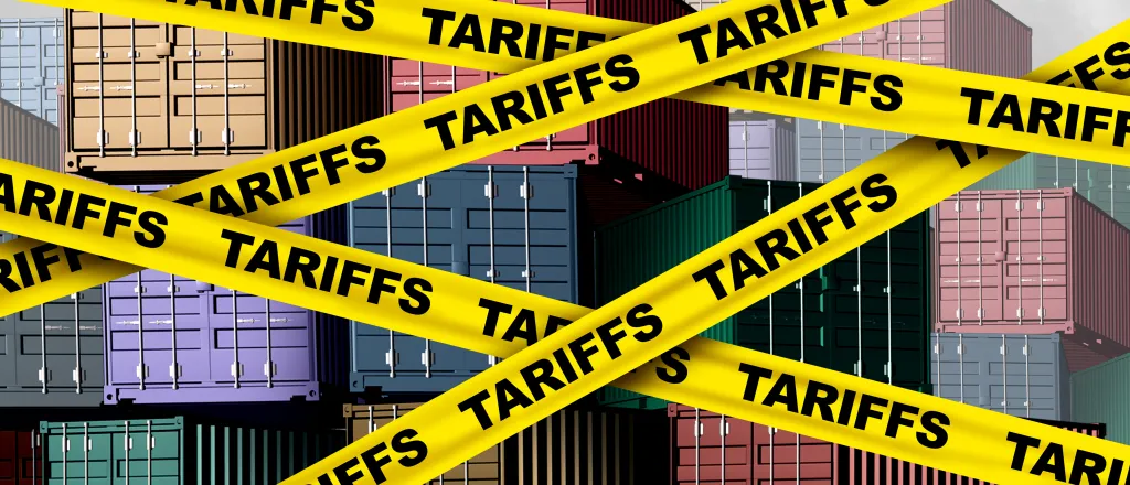 PROMO HIRES CROPPED Trade - Tariffs Shipping Transportation Taxes Politics - wildpixel - iStock-2189862167 Artist's representation of cargo shipping containers with yellow banners in front labeled with the word "tariff"