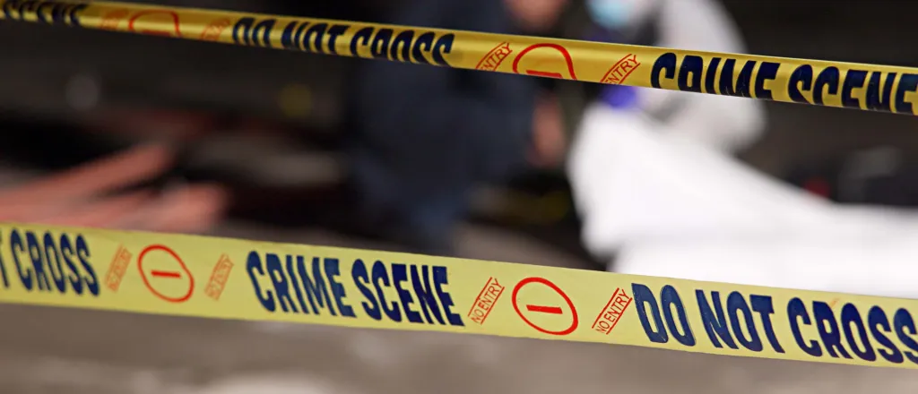 PROMO HIRES CROPPED Crime - Scene Tape Invesigation Law Enforcement Police Justice - Jacob Wackerhausen - iStock-2184583932 Close up of crime scene tape, which has the words "Do not cross," "No entry," and "Crime scene" printed in a repeating pattern.