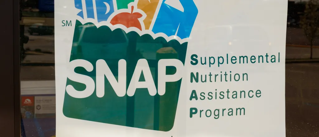 Photo of a sign the Supplemental Nutrition Assistance Program (SNAP) in a store window.