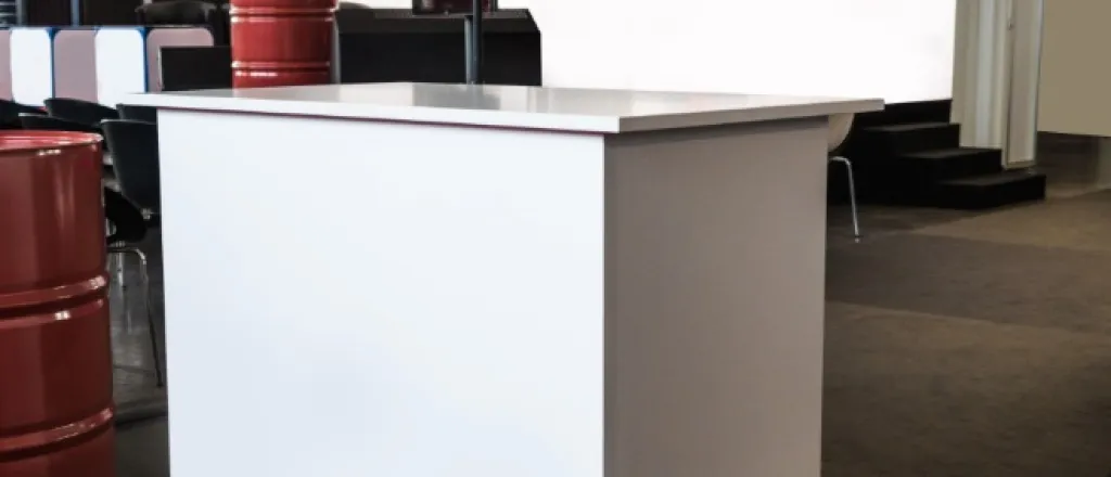 A setup of a marketing booth at a trade show with a stand and several other blank white components.