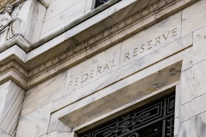 Stone building with the words "Federal Reserve" over a doorway
