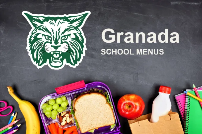 The Granada School Bobcats mascot, chalked on a blackboard above a packed school lunch of a sandwich, grapes, carrots, an apple and a bottle of milk, with pencils and notebooks. The board reads “Granada School Menus”.