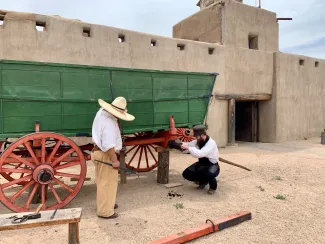 PICT Bent's Old Fort park staff greasing the axle of the park's green Conestoga Wagon. Courtesy NPS - Jake Koch PICT Bent's Old Fort park staff greasing the axle of the park's green Conestoga Wagon. Courtesy NPS - Jake Koch