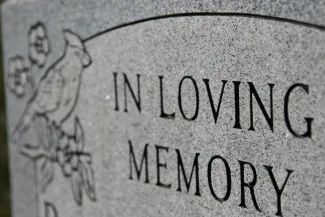 Grave marker inscribed with 'In Loving Memory' - iStock - melissarobison Grave marker inscribed with 'In Loving Memory' - iStock - melissarobison