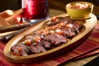 Plate of Argentinean Grilled Steak with Salsa Criolla