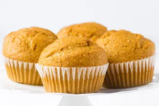 Plate of four basic muffins in paper cups