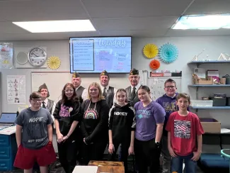 Cheyenne Wells Patriot's Pen contest winners. Students standing in a classroom.