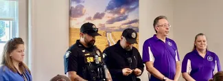 Kiowa County first responders honored. People standing in line posing for photos.