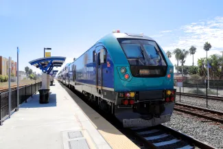 Light rail passenger train stopped at a station platform