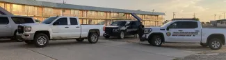 Kiowa County Sheriff's Office vehicles surrounding a pickup in front of a motel. Kiowa County Sheriff's Office vehicles surrounding a pickup in front of a motel.