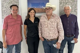 Towner Office Opening Landowners - Invenergy Four people posing for a photo.
