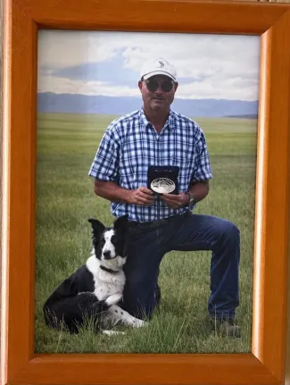 Memorial photo of Tony Steward with dog and award