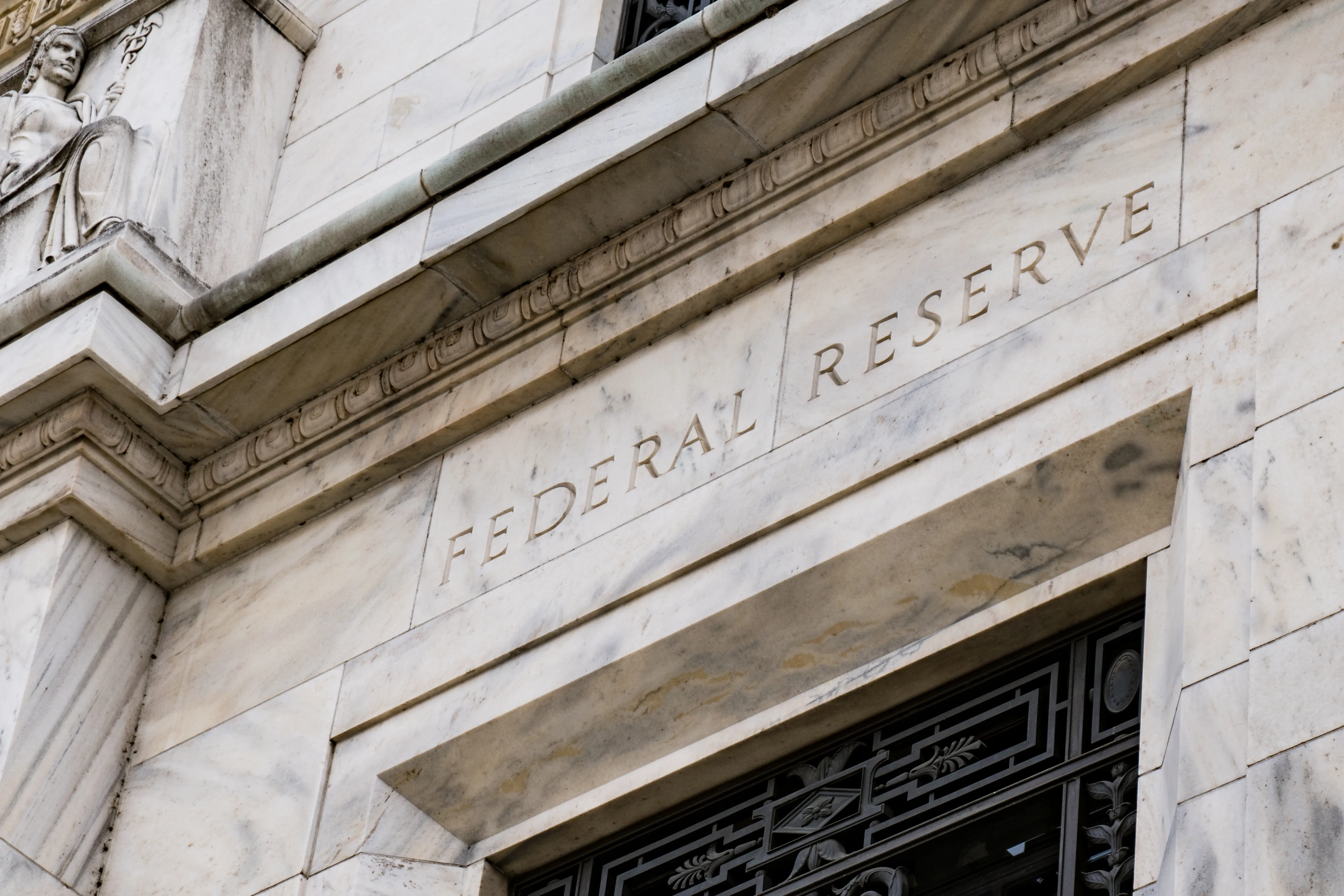 Stone building with the words "Federal Reserve" over a doorway