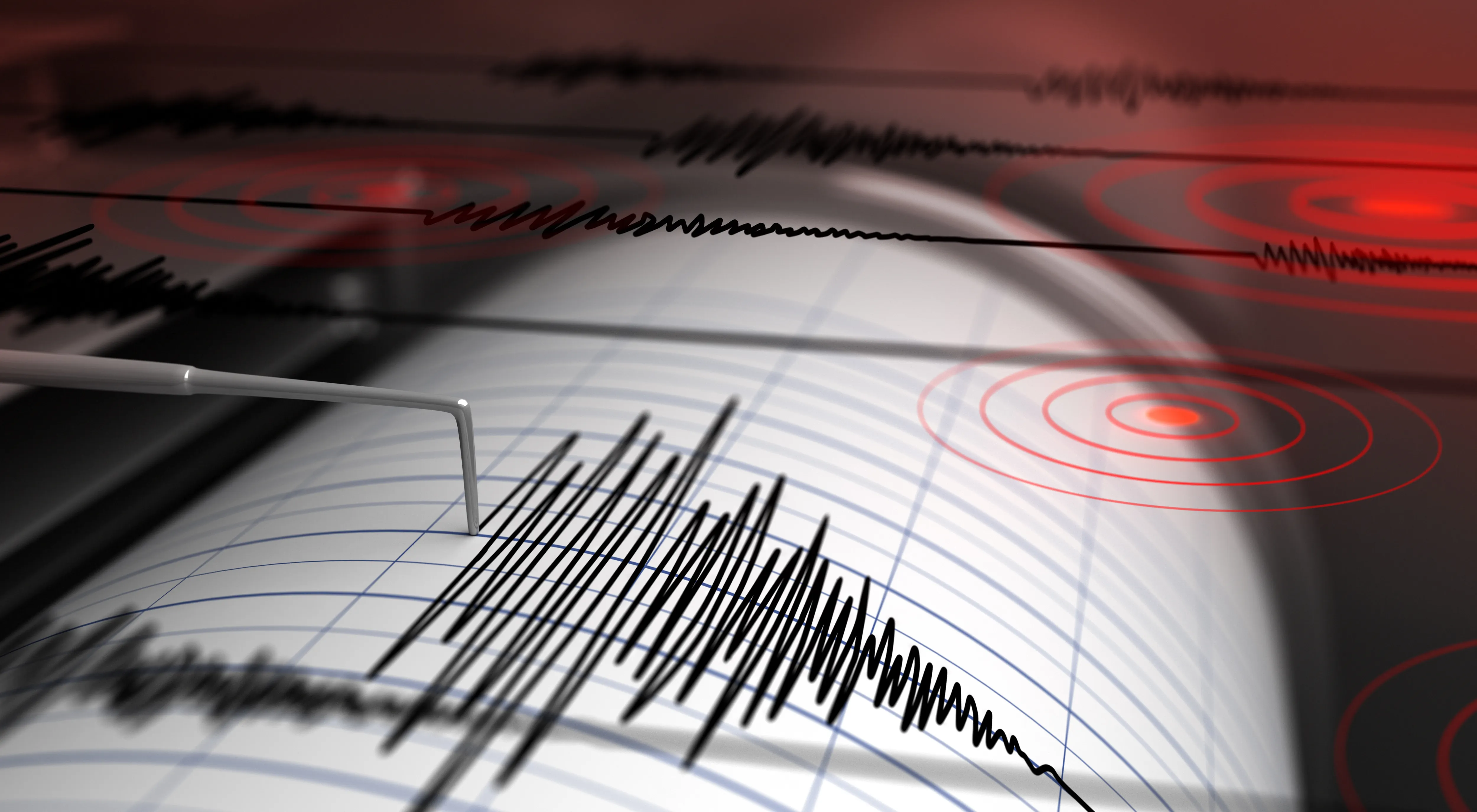 Earthquake seismograph drum with a stylus pen recording a large disturbance.