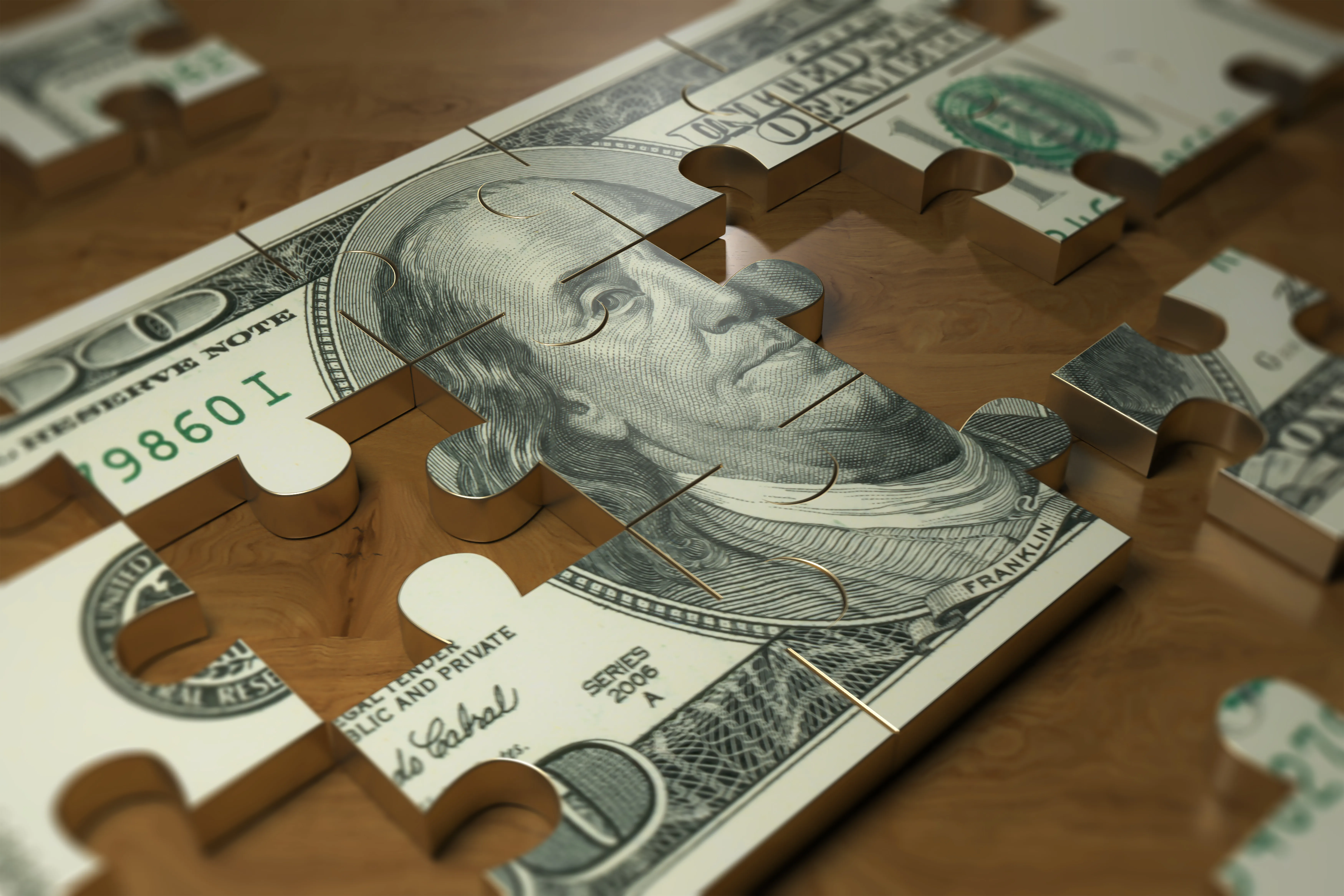 Metal puzzle of a United States five dollar bill with pieces removed or missing.
