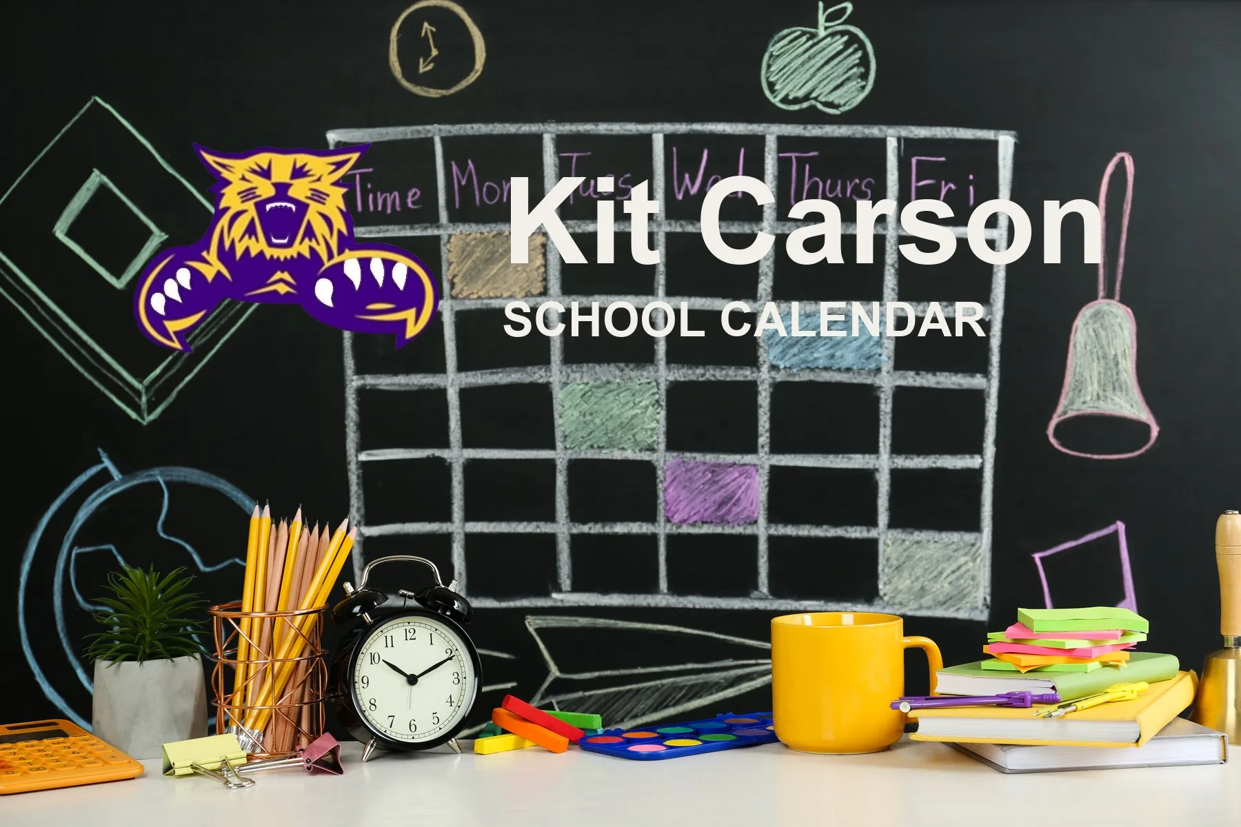 The Kit Carson School Wildcats mascot, beside a chalkboard drawn with a weekly calendar grid above a desk of pencils, a clock and notebooks. The board reads “Kit Carson School Calendar”.