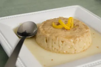 Classic Honey Flan - USDA Flan on a plate with a spoon.