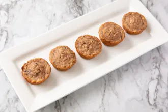 Wild Rice Muffins - USDA Rectangular plate on a marble surface containing 5 wild rice muffins