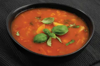 Lentil Barley Soup - USDA Bowl of lentil barley soup with fresh oregano leaves as a garnish