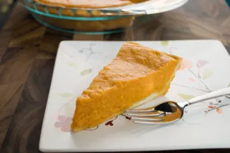 Mock Southern Sweet Potato Pie - USDA Slice of mock souther sweet potato pie on a square plate with a fork.