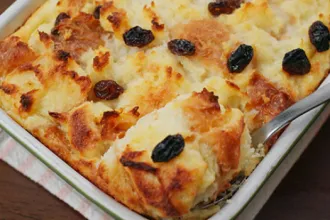 PICT RECIPE Old Fashioned Bread Pudding - USDA Tray of cooked old fashioned bread pudding with a serving utensil.