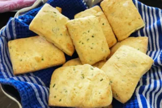 Parmesan Chive Biscuits - USDA Cloth holding eight parmesan chive biscuits
