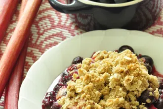 Rhubarb Blueberry Crisp - USDA Bowl of Rhubarb Blueberry Crisp next to a cup.