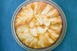 Overhead view of an apple cake showing apple slices arranged in a circular pattern.