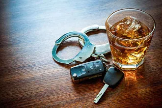 Crime - Drink Drive Whiskey Alcohol Key Fob Handcuff Table Glass - iStock - AlexRaths